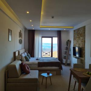 a bedroom with a bed and a living room at Mountain Side Kopaonik in Kopaonik