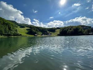a view of a lake with trees and a sky at La casa nel borgo in Terrarossa