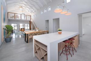 a kitchen and dining room with a white counter top at Klapperbos Stilbaai in Stilbaai