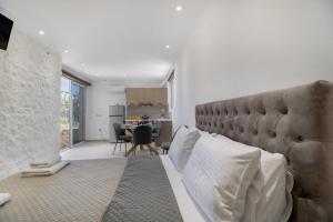 a living room with a couch and a table at Gkountis Garden Studio in Tsoukaladhes