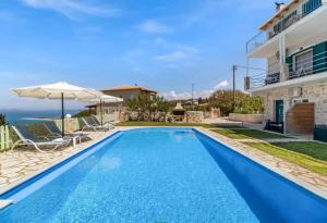 a swimming pool in a villa with a view of the ocean at Gkountis Garden Studio in Tsoukaladhes