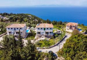 an aerial view of a house with the ocean in the background at Gkountis Garden Studio in Tsoukaladhes