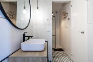 a bathroom with a white tub and a mirror at Torre Mirador Azul 2 habitaciones in Tossa de Mar +26 photos