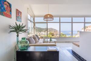 a living room with a couch and a table at Torre Mirador Azul 2 habitaciones in Tossa de Mar