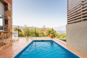 a swimming pool on the side of a building at Torre Mirador Azul 2 habitaciones in Tossa de Mar