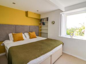 a bedroom with a large bed and a window at 1 Gibraltar Terrace in Aberdyfi
