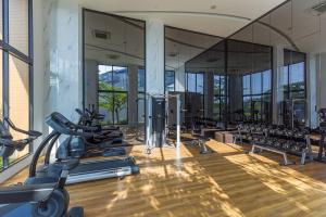 a gym with a lot of treadmills and ellipticals at 1BDR apartment with private terrace with jacuzzi and sea view by My Home Phuket in Ban Lum Fuang