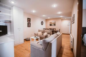a living room with a couch and a table at Las Ayalgas, apartamento en Llanes VUT-3935-AS in Llanes