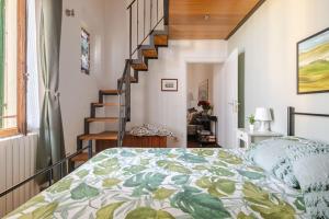 a bedroom with a bed and a staircase at Le Cure in Florence