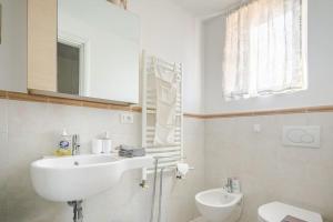 a white bathroom with a sink and a toilet at Le Cure in Florence +37 photos