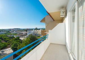 a balcony with a view of the ocean at Merryland Studios & Apartments in Kremasti