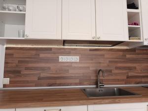 a kitchen with white cabinets and a sink at Sun Holidays Byala in Byala +10 photos