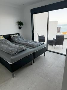 a bed in a room with a view of the ocean at El Mirador Casa #8 in Torrox Costa