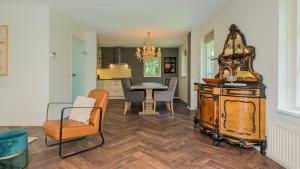 a kitchen and dining room with a table and chairs at De IJsvogel in Schoorl