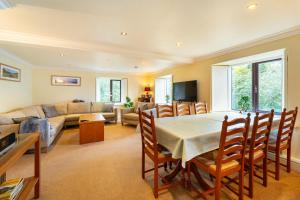 a living room with a table and a couch at Mill Top in Ambleside