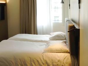 Postel nebo postele na pokoji v ubytování ibis Lille Centre Grand Place