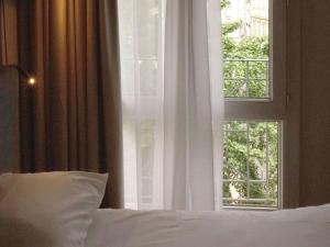 Postel nebo postele na pokoji v ubytování ibis Lille Centre Grand Place