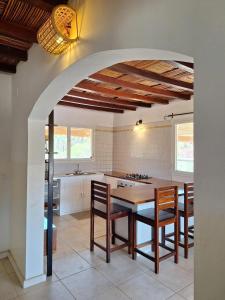 a kitchen with a table and chairs in a kitchen at Cozy house with sea view in Boukot Ouolof
