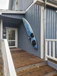 a blue kayak hanging on the side of a house at Gästehaus Wolkenlos in Fehmarn