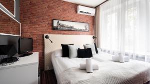 Ένα ή περισσότερα κρεβάτια σε δωμάτιο στο Hotel Delta