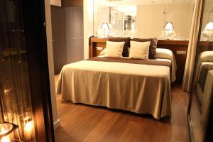 Postel nebo postele na pokoji v ubytování Hotel Don Paco