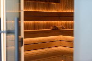 a sauna with wood paneling and a door with at BERGlässig Hotel - Halbpension Plus inkl Getränke in Bodenmais +70 photos