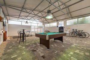 a room with a pool table and some bikes at Villa Štrkalj ZadarVillas in Murvica