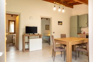 a kitchen and dining room with a table and a television at Chalet La Greta Vista Superiore in Firenzuola