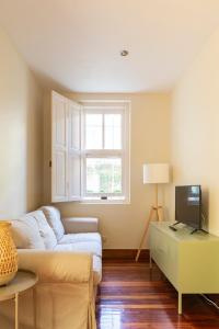a living room with a couch and a window at Casabonita Santander in Santander