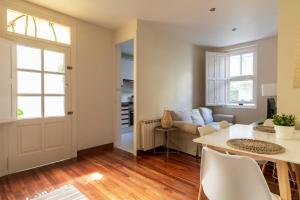 a living room with a table and a couch at Casabonita Santander in Santander
