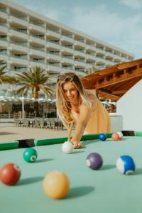 a woman playing pool on a pool table at Olé Tropical Tenerife Adults Only in Playa de las Americas