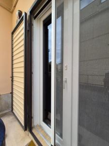 a sliding glass door on the side of a house at Loft piano terra a 300m dal mare in Terracina
