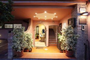 a front door of a house with two potted plants at Mendolia Beach Hotel in Taormina