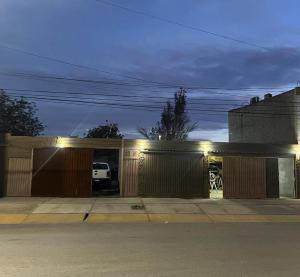 a house with a garage at night with lights at Rufina Departamentos - Con cochera in San Juan