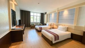 Postel nebo postele na pokoji v ubytování Siamgrand Hotel + 25 fotografií