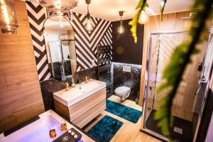 a bathroom with a sink and a toilet at Tropical Jacuzzi Oasis - Terreaux in Lyon