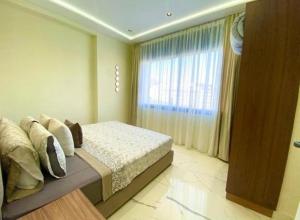 a bedroom with a bed and a large window at Appartement Centre ville Tanger in Tangier