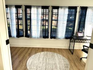 a room with a window with curtains and a rug at Downtown Retreat - Cozy First Floor in Columbus