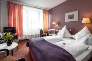 Postel nebo postele na pokoji v ubytování Parkhotel Hitzacker