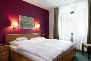 Postel nebo postele na pokoji v ubytování Parkhotel Hitzacker