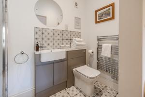 a bathroom with a toilet and a sink and a mirror at The Star Inn - Harbottle - Near Rothbury - Northumberland in Morpeth +35 photos