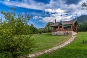 a cabin in the middle of a grassy field at Mountain Escape Chalet in Karpenision