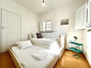 Ένα ή περισσότερα κρεβάτια σε δωμάτιο στο Estoril Beach House