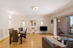 a living room with a couch and a table at HolidaysPT - MyOasis I - T2 Apartment in Olhão