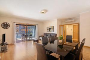 a dining room and living room with a table and chairs at HolidaysPT - MyOasis I - T2 Apartment in Olhão