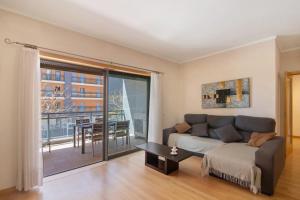 a living room with a couch and a table at HolidaysPT - MyOasis I - T2 Apartment in Olhão
