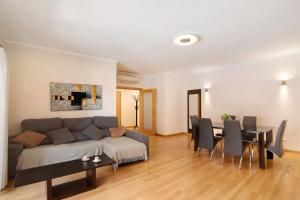 a living room with a couch and a table and chairs at HolidaysPT - MyOasis I - T2 Apartment in Olhão +18 photos