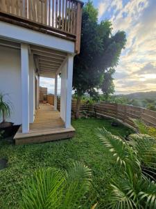 a porch of a house with a wooden deck at Villa Entre-Deux Centre in LʼEntre-Deux +50 photos