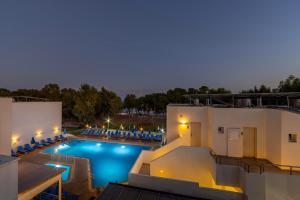 a view of a swimming pool at night at Park Beach Hotel in Limassol