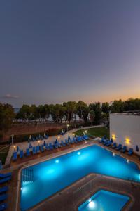 an overhead view of a swimming pool with lounge chairs at Park Beach Hotel in Limassol
